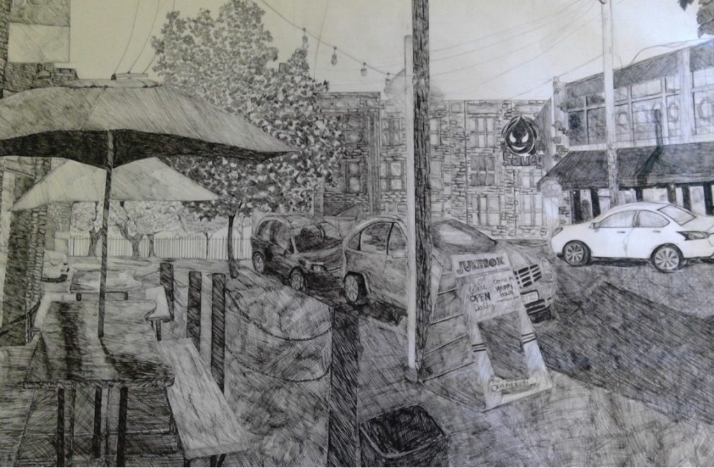 Pencil sketch/drawing of a busy street with cafes, storefronts, and cars. 