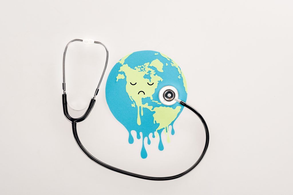 Depiction of a melting or sweating globe with a stethoscope around it. 