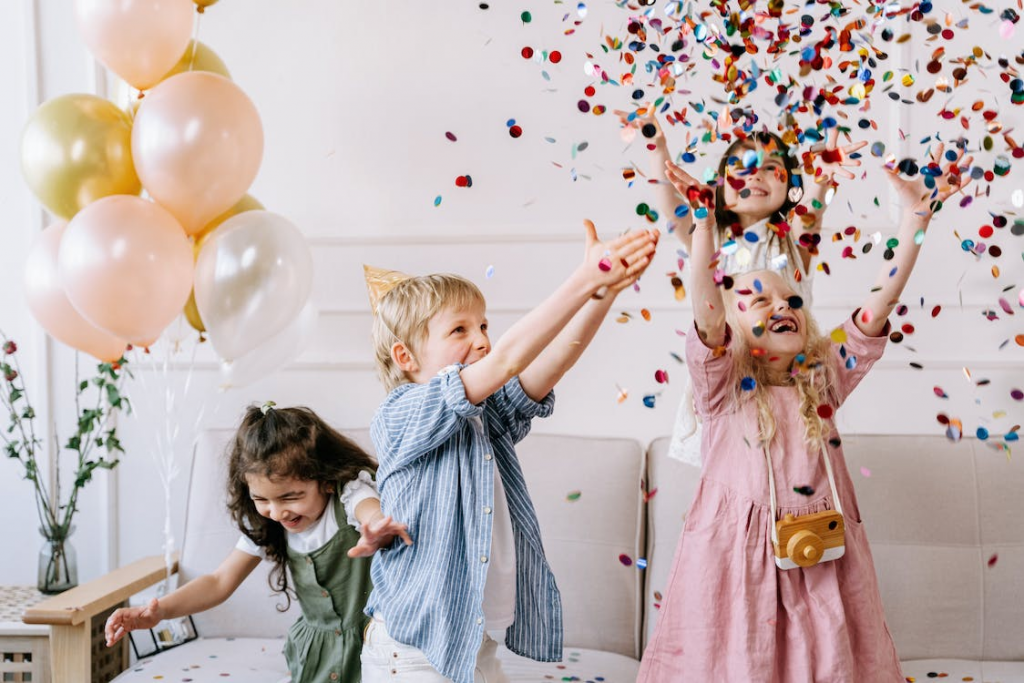 Children are playing with confetti during a party.