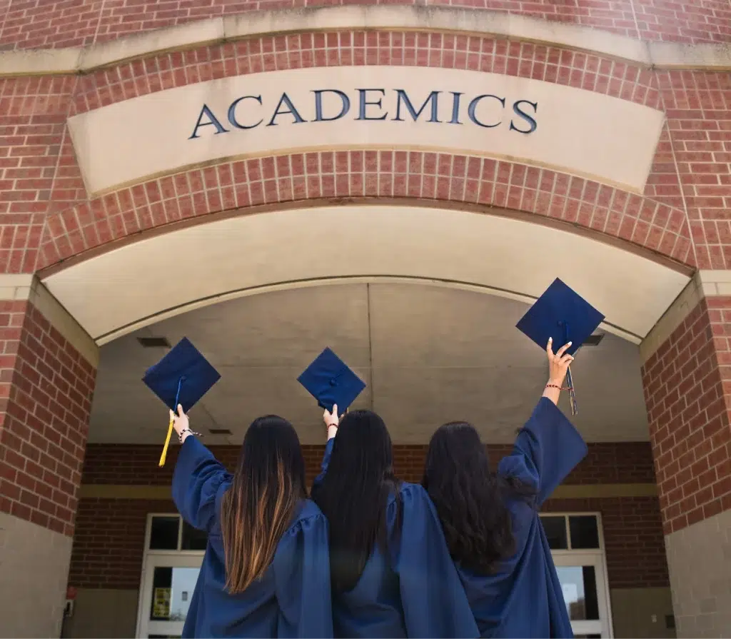 students in front of university celebrating their graduation
