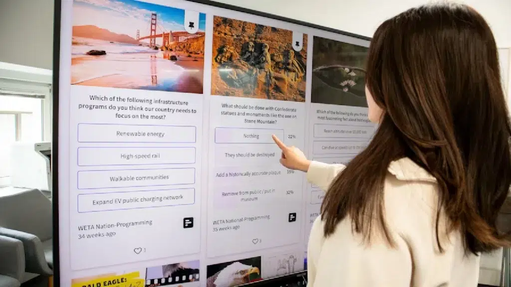 young female stands in front of a touch screen and makes her choices on the screen