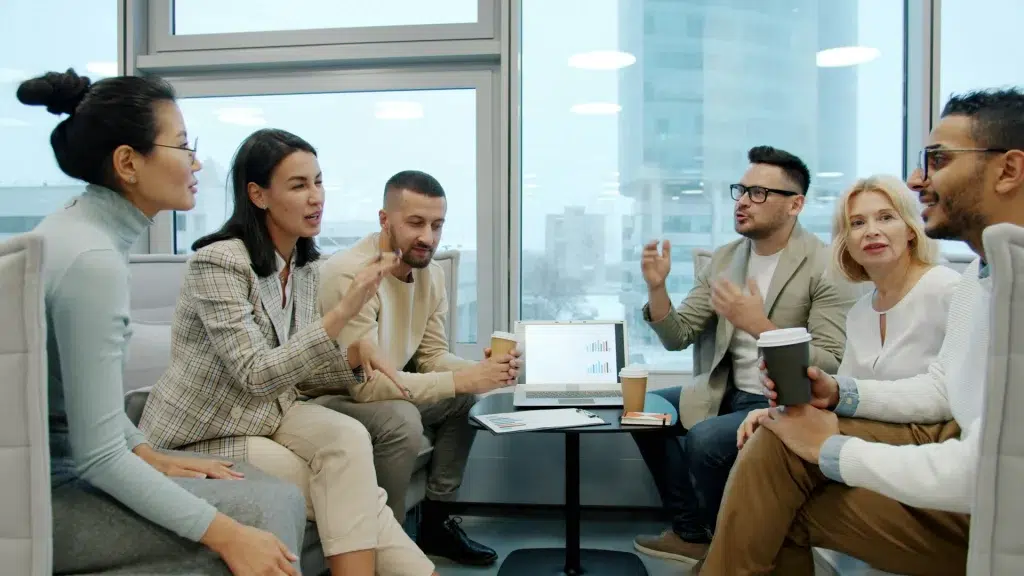 Diverse group of people in a modern office meeting.