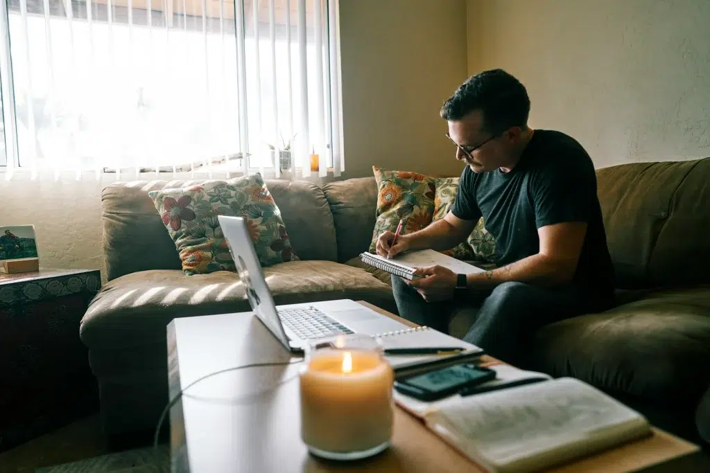 Man in black crew neck t-shirt sitting on couch